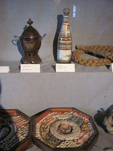 Sailors' valentines, guano bottle art, and a coconut shell decorative dish at the Maritime Museum, Halifax. Photo by the author.
