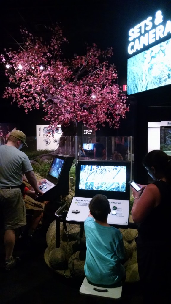 This station allowed you to play with camera angles from several different cameras, and also allowed you to physically climb underneath for a literal bug's eye view of the constructed set. Simple, effective, great presentation value, and a nice way to tie in both the research Pixar did ahead of A Bug's Life and the directorial choices available when all your cameras are virtual.